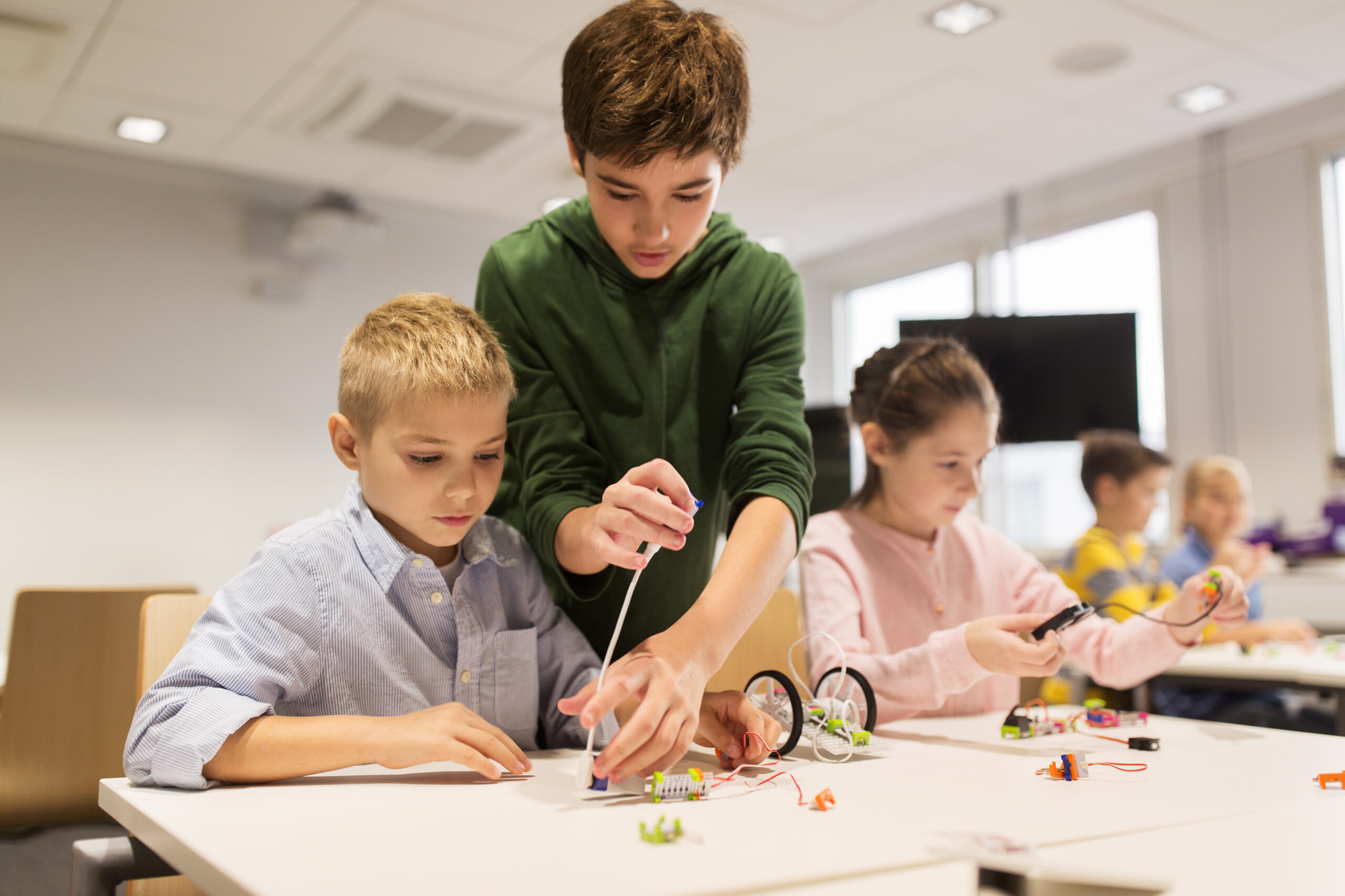 happy children building robots at robotics school