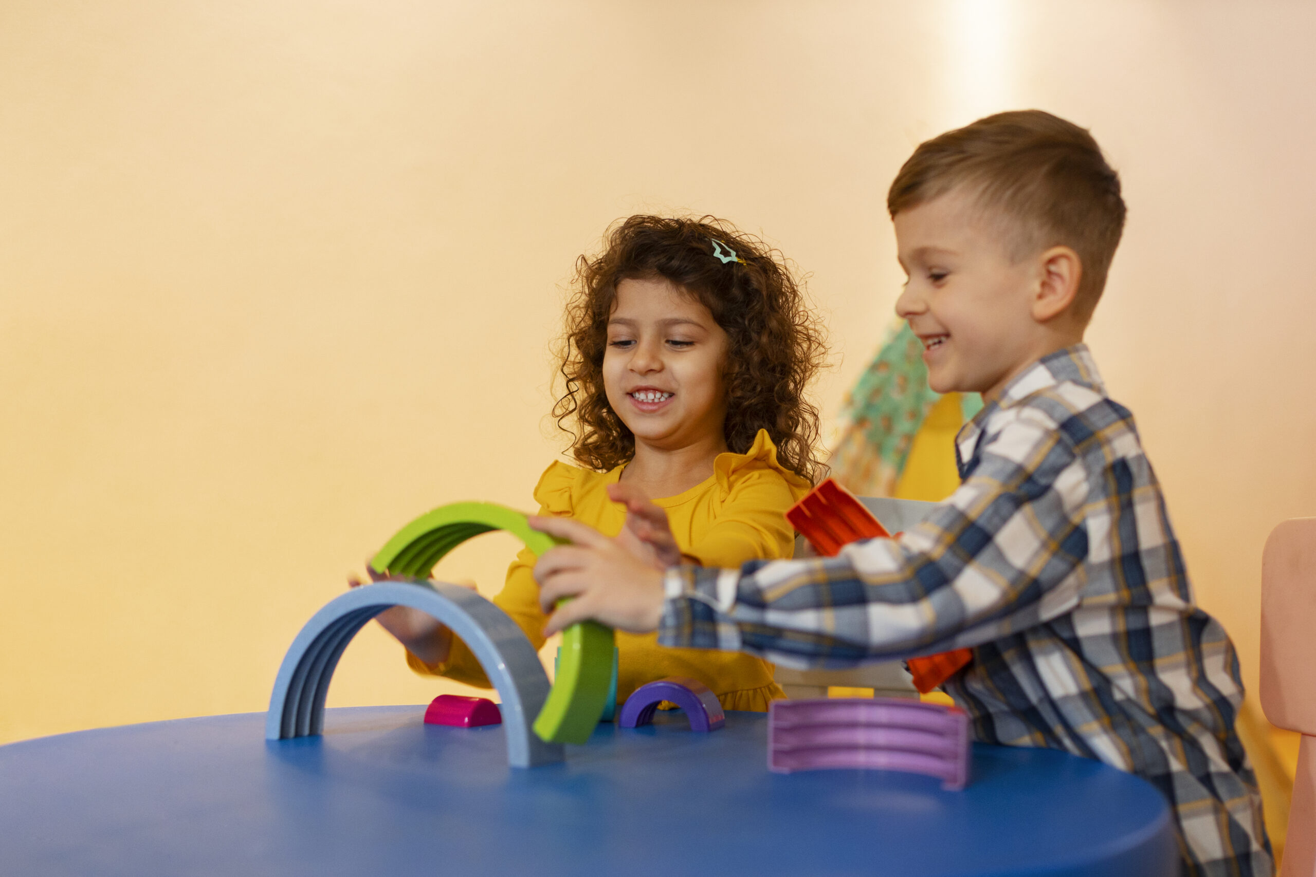 young-boy-girl-playing-indoors-with-eco-toys