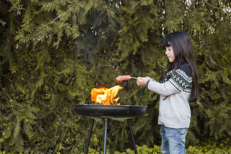 girl-grilling-sausages-flame-outdoor-barbecue-min