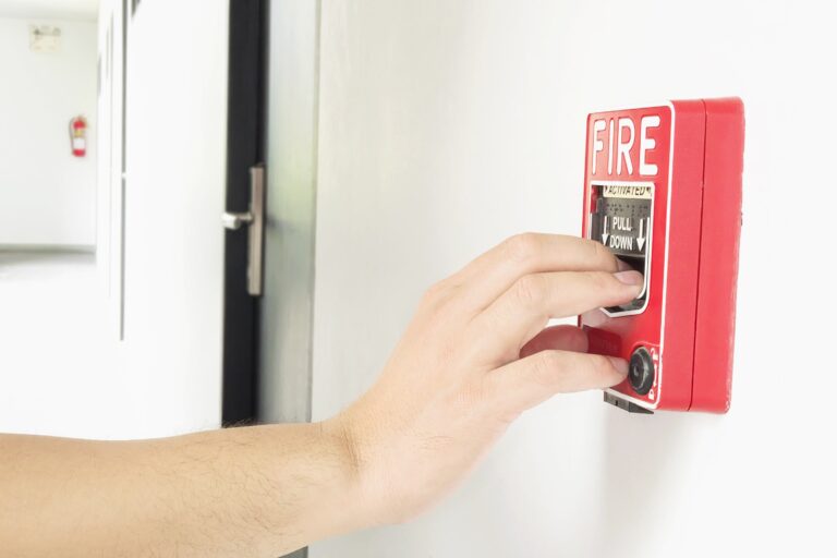 man-is-reaching-his-hand-push-fire-alarm-hand-station (2)-min